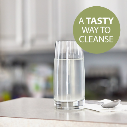 NutriClean Advanced Fiber Powder with Stevia, a tasty way to cleanse, shown mixed in a glass of water on a table with a napkin and spoon