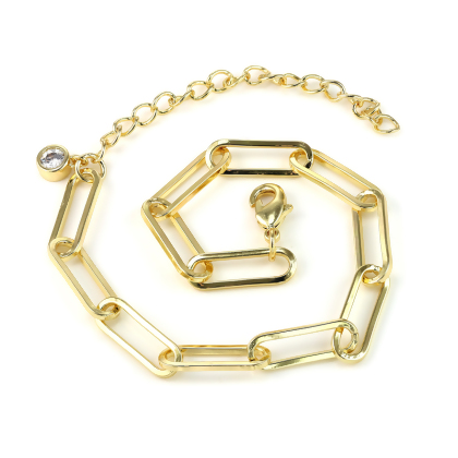 Closeup of Layered JUSTINE Paperclip Bracelet in gold, laying flat in a spiral