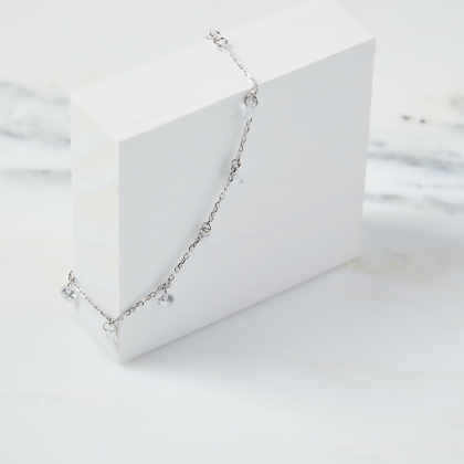 Layered Desi - Pierced Round Cut Bracelet in silver, displayed on a white box